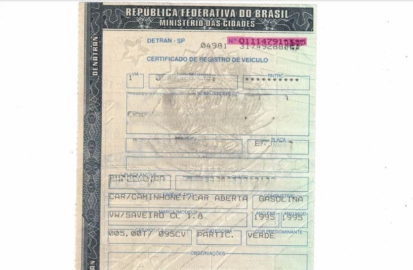 CRV antigo em papel com o número do CRV e o código de segurança no canto superior direito
